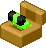 a goofy green critter arises out of a pot of dirt